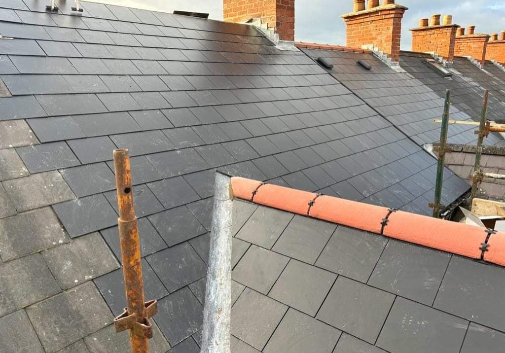 roofers fixing damaged tiles on a dublin home